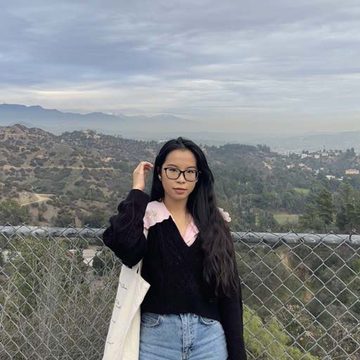 Mia posing in front of hills and mountains
