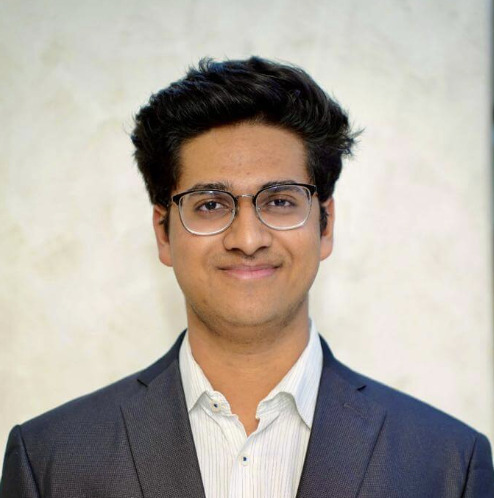 Utkarsh smiling in a suit